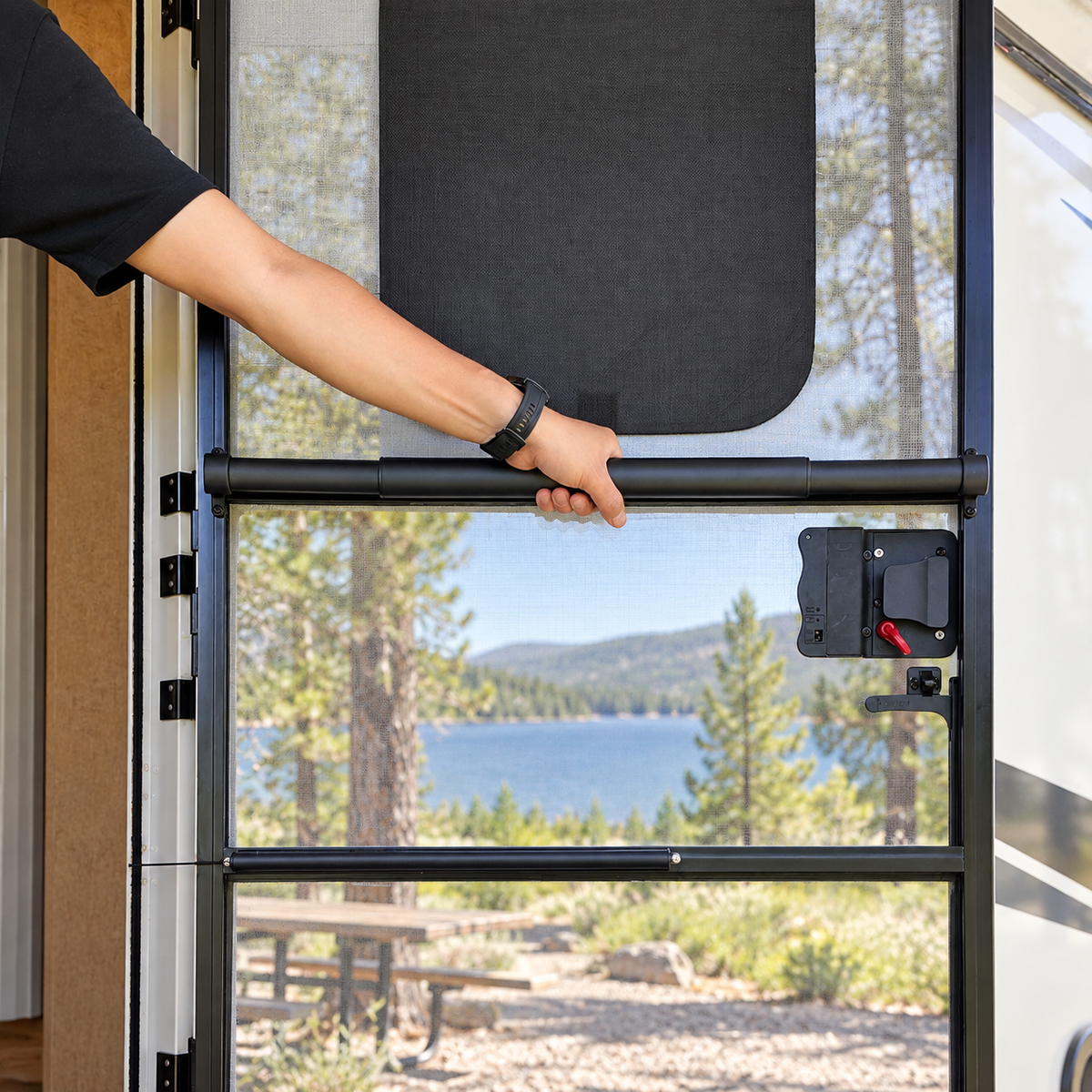 Using the full-width crossbar handle to open an RV screen door