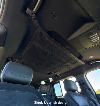 Empty overhead cargo net installed in a black SUV interior