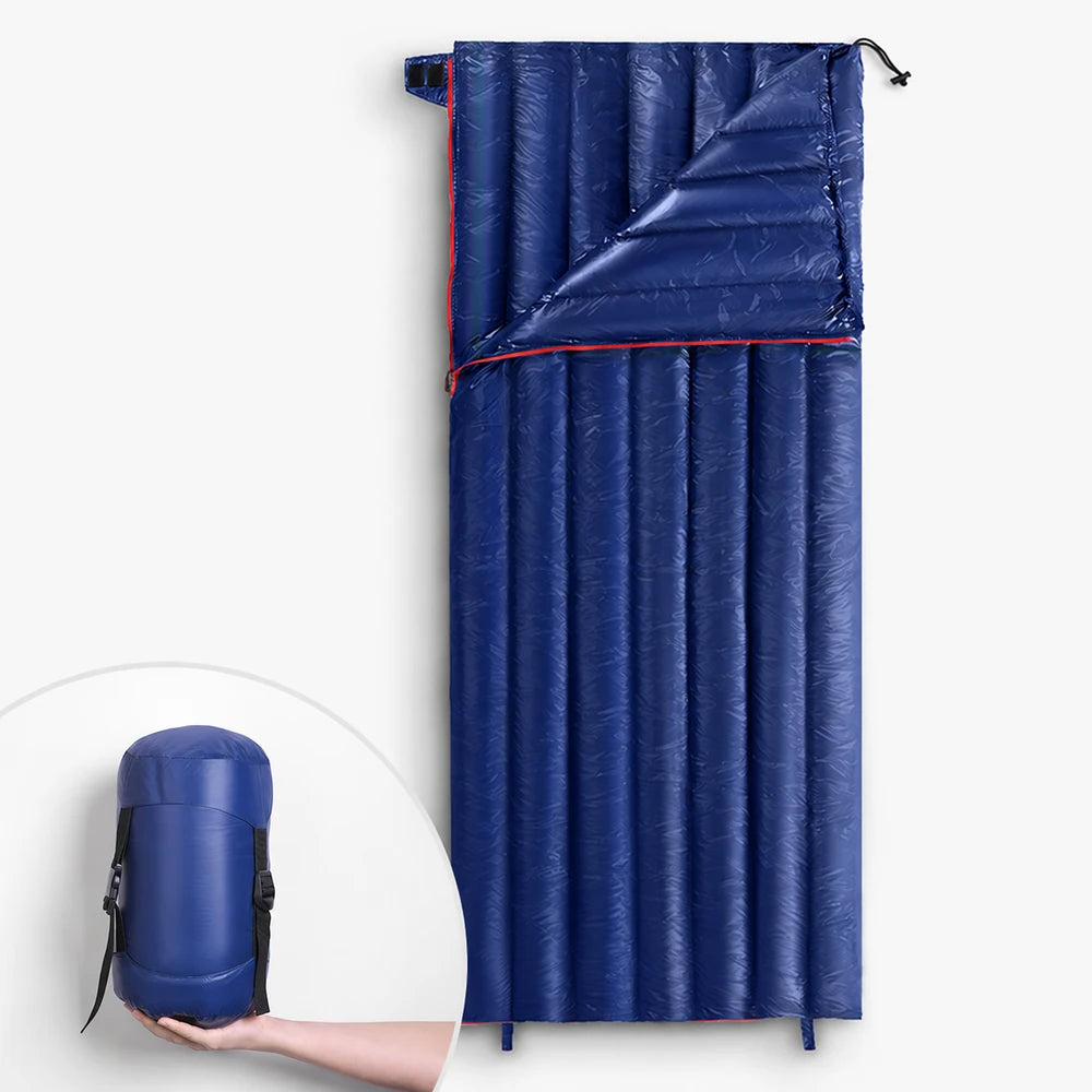 Unbranded blue ultralight rectangular down sleeping bag shown open with compact storage sack