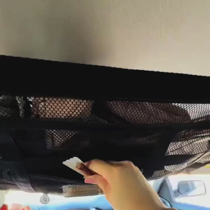 Overhead car ceiling storage net frees passenger and boot space